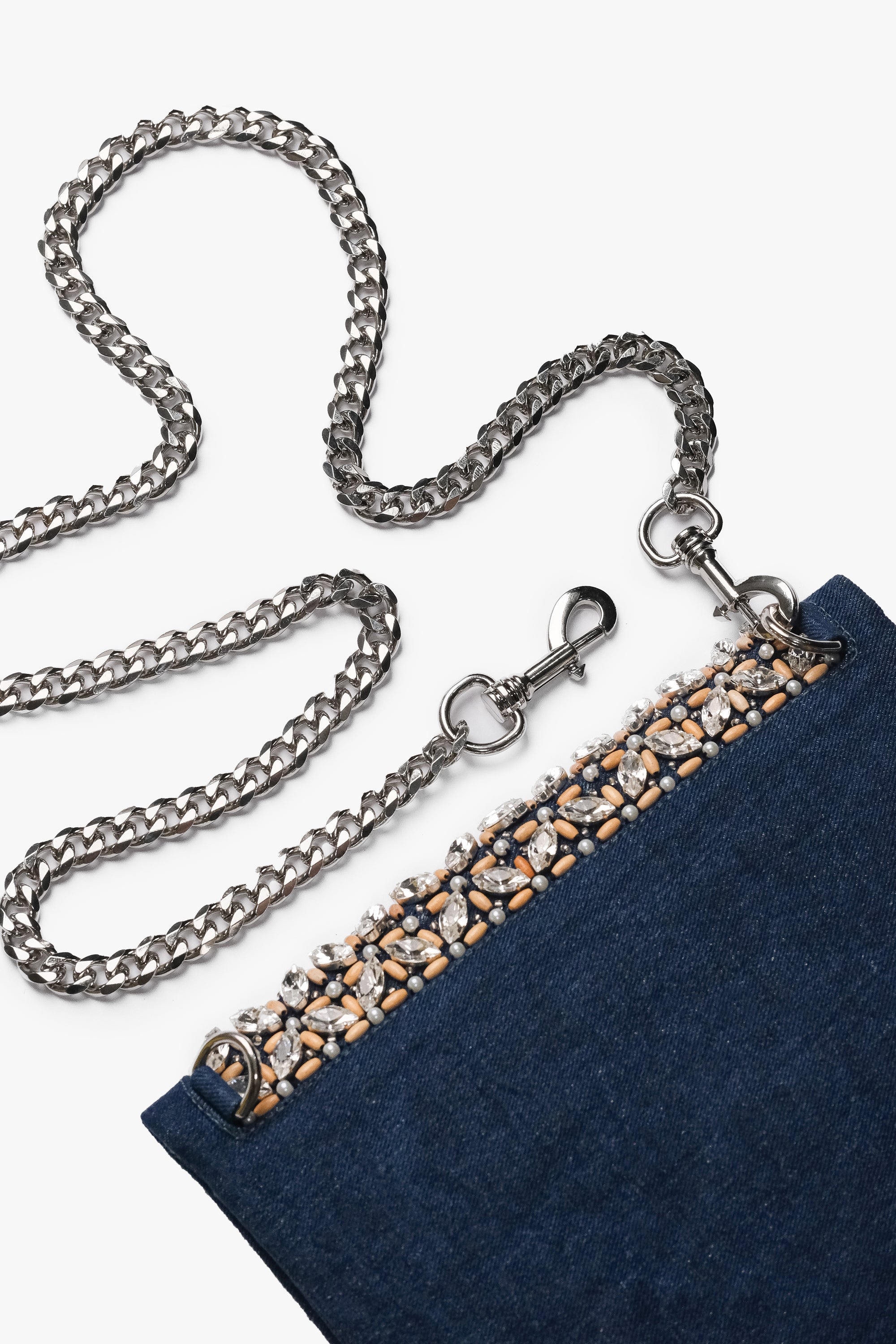 Acambha's Crystal Bead Glam Clutch features delicate crystal beading, pearls, and wooden beads, with a zipper and magnet button on the flap. This clutch showcases meticulous craftsmanship.