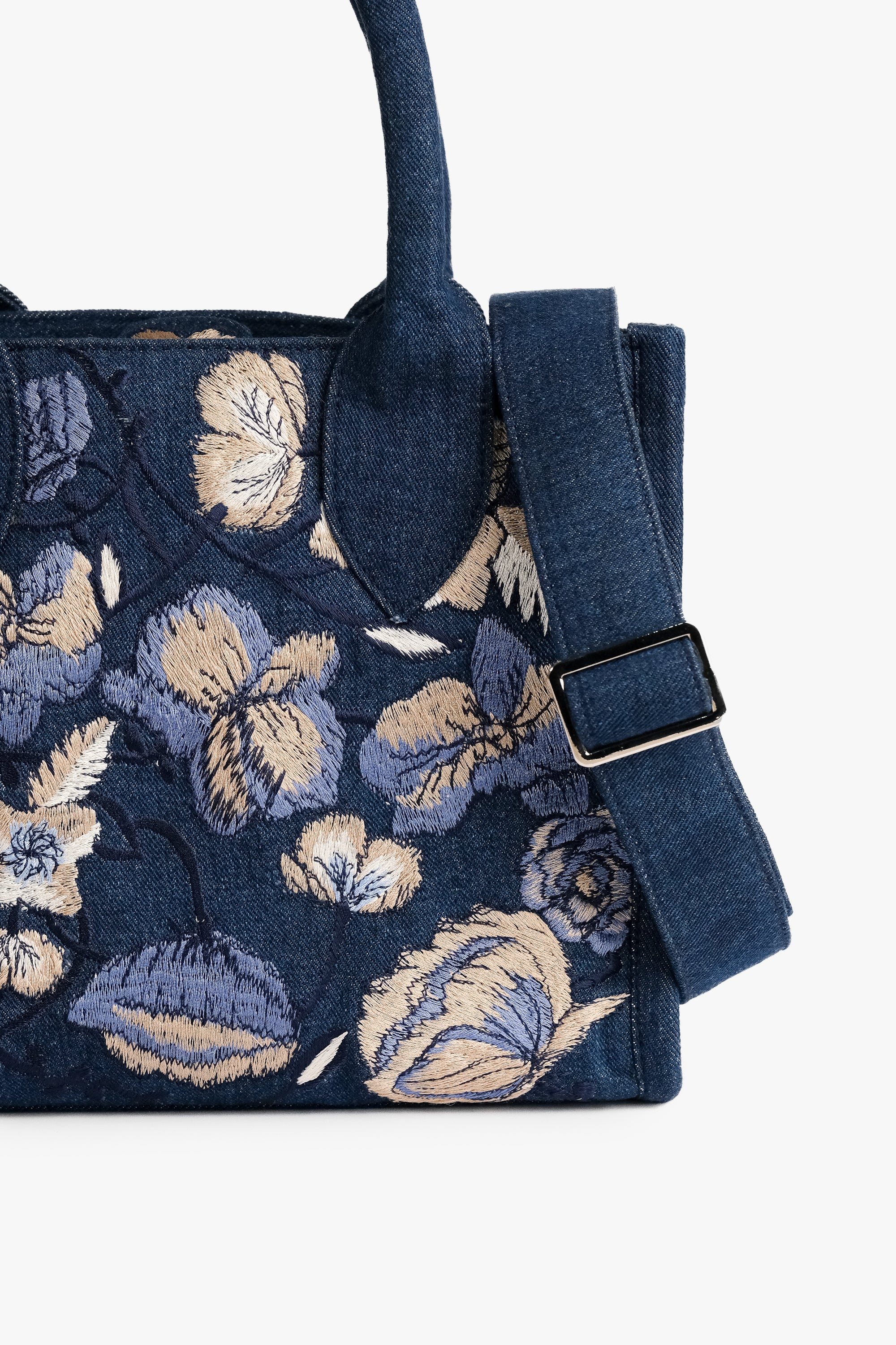 Acambha Tote Bag with embroidered flowers on dark denim. Handmade with care.. Spacious interior and sturdy construction combine practicality with charm.