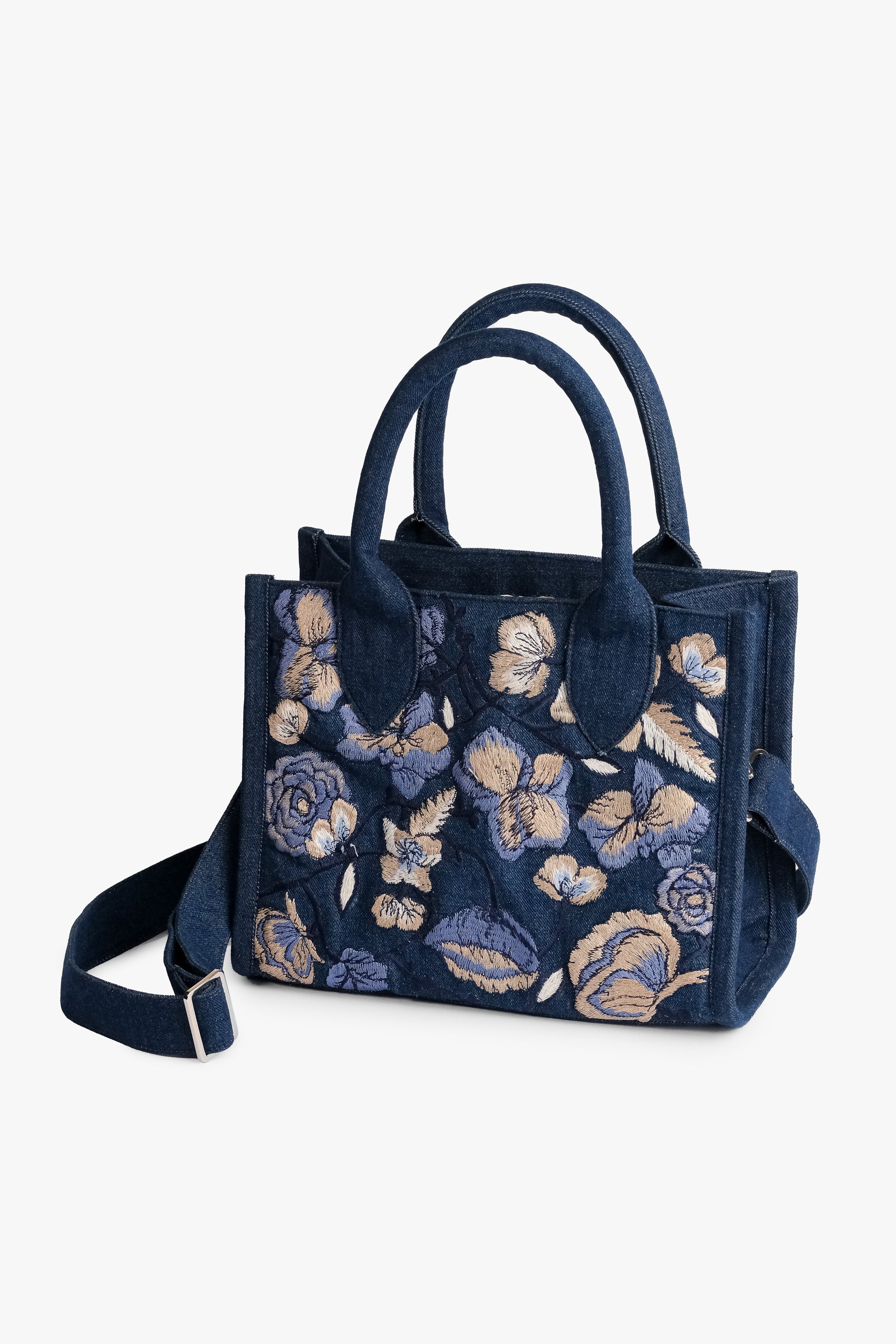 Acambha Tote Bag with embroidered flowers on dark denim. Handmade with care.. Spacious interior and sturdy construction combine practicality with charm.