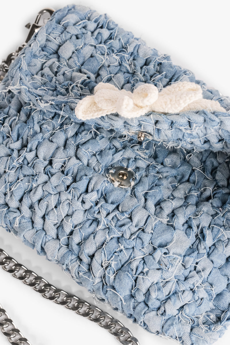 Daisy Denim Crochet Clutch made from upcycled denim strips with a press stud closure. Features a crochet flower and frayed design