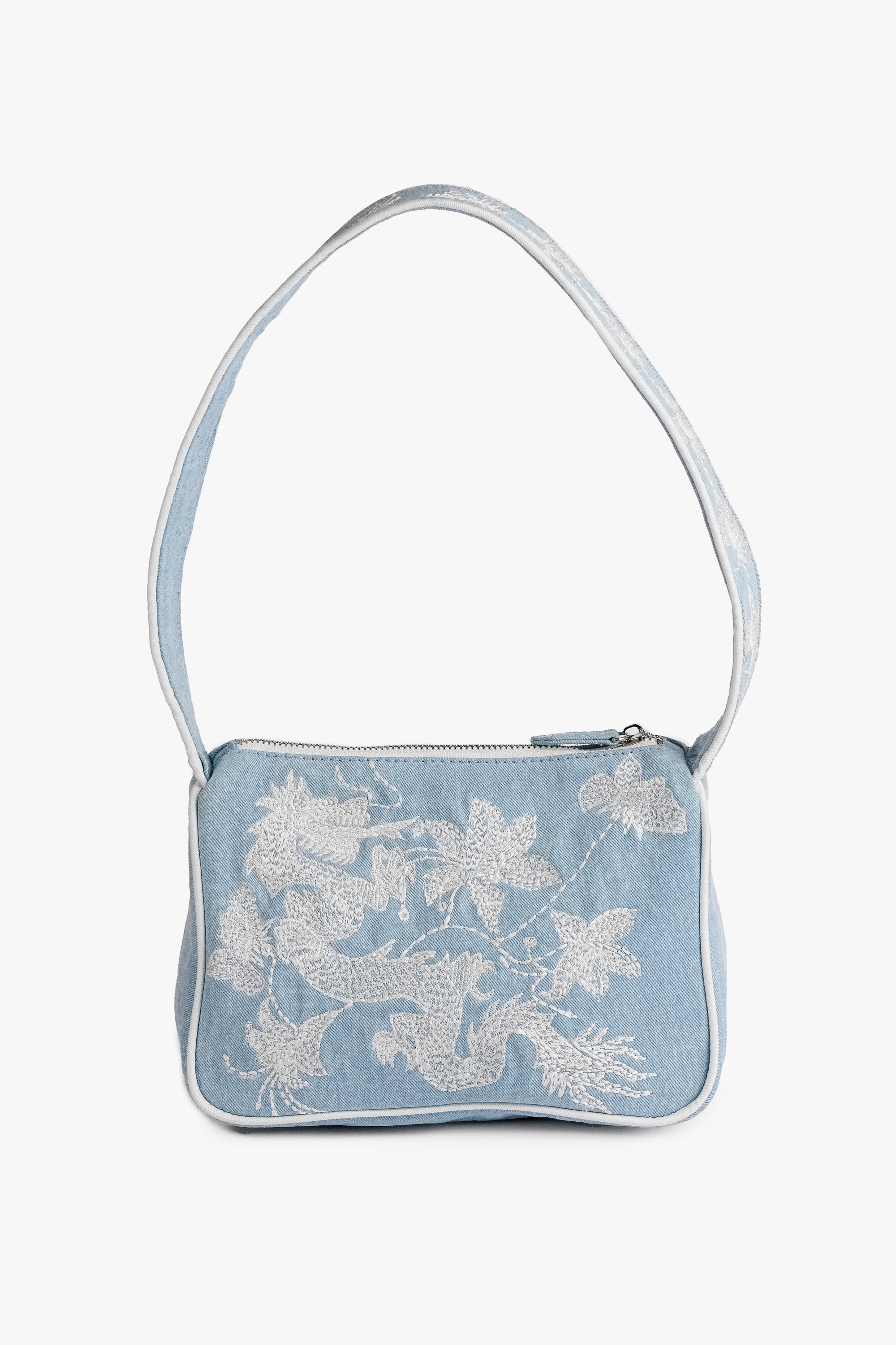 Acambha's Embroidered Dragon & Flowers Shoulder Bag with intricate embroidery of a dragon and flowers on light denim. Features a zipper closure and white embroidery on the body and strap