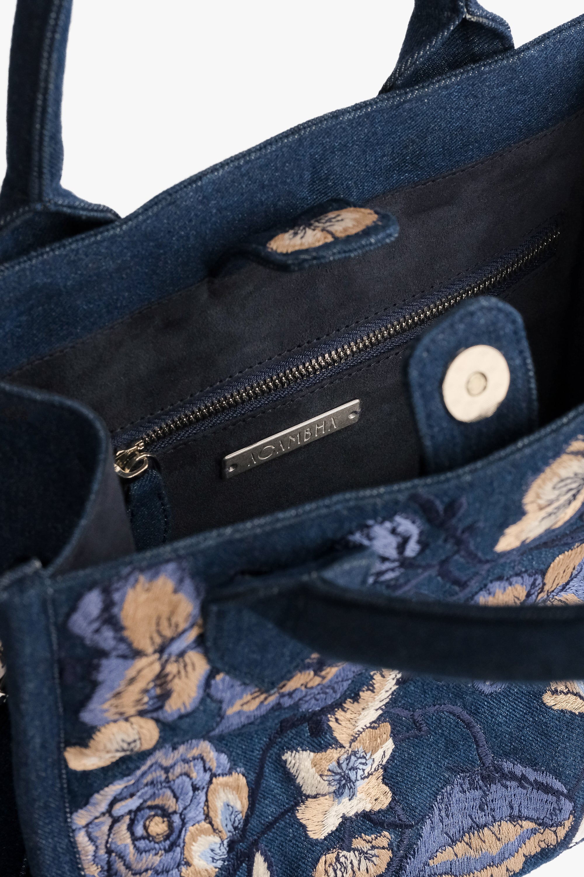 Acambha Tote Bag with embroidered flowers on dark denim. Handmade with care.. Spacious interior and sturdy construction combine practicality with charm.